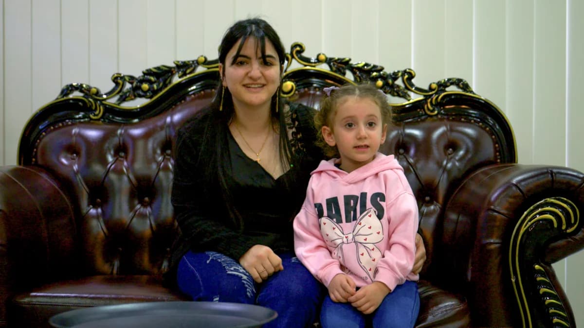 Happy mother and daughter sitting comfortably in their newly moved Sydney home