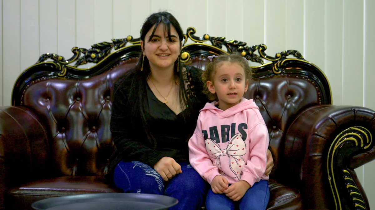 Happy mother and daughter sitting comfortably in their newly moved Sydney home