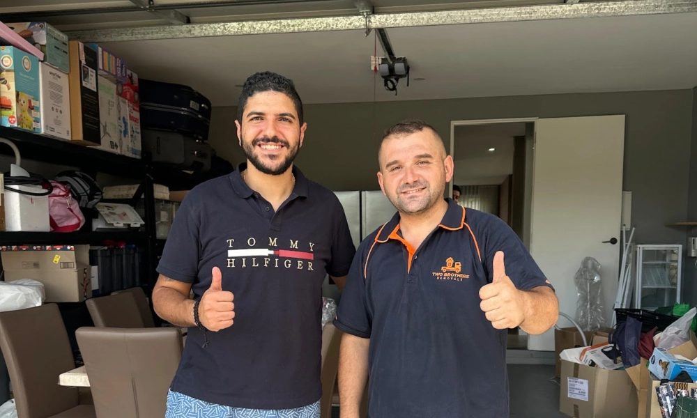 Customer and Two Brothers removalist giving a thumbs up in the garage after a smooth unload