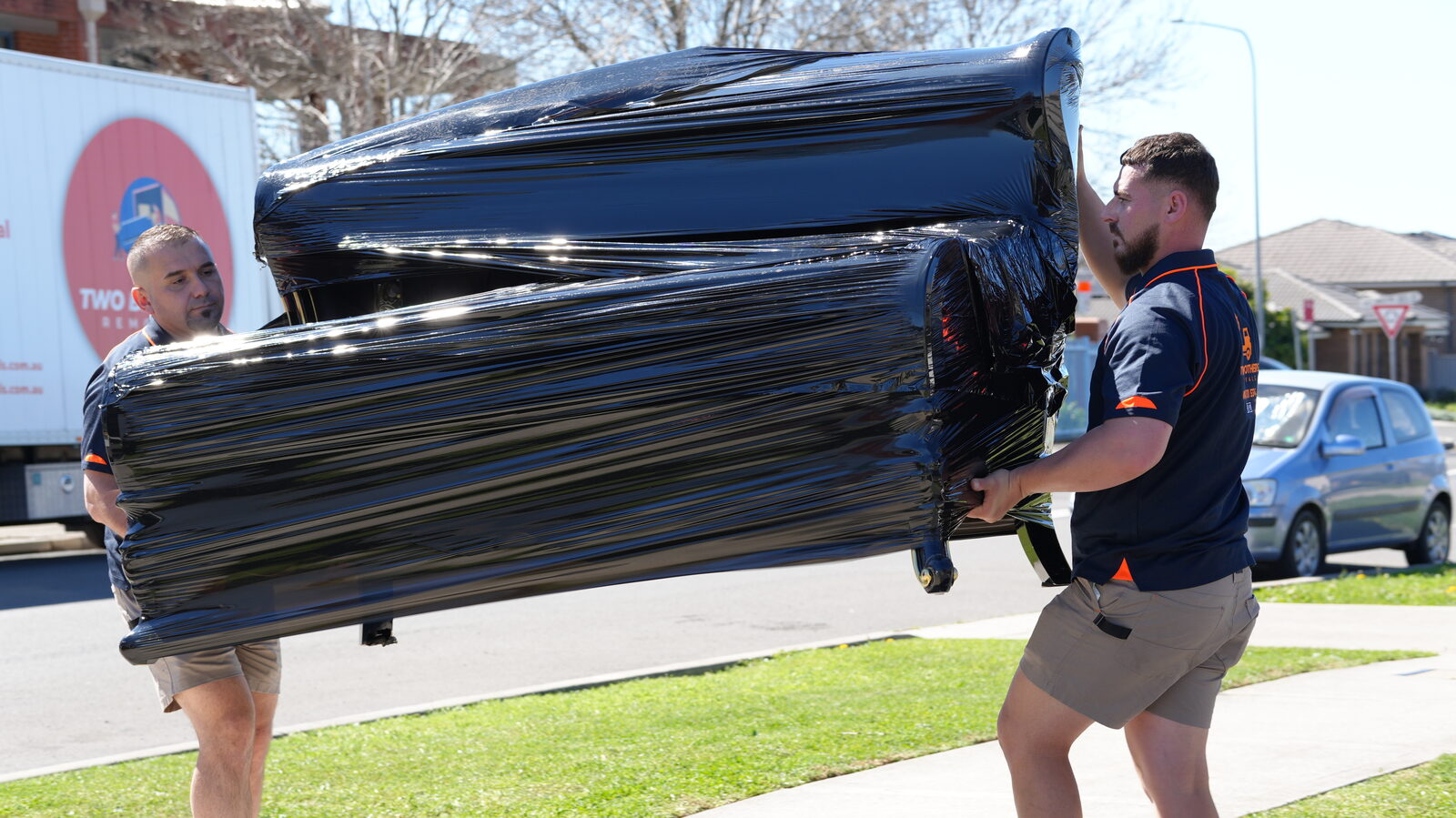 Two of our crew carrying a wrapped item together