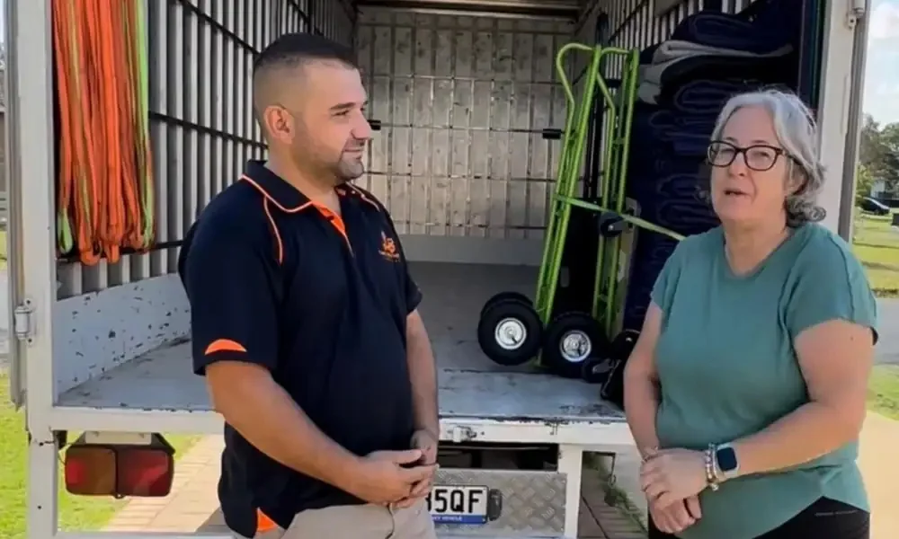 Removalist discussing a move with a customer beside the truck